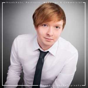 High-quality headshot of an actor against a studio backdrop