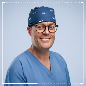 Candid headshot of a man in a corporate setting with natural lighting