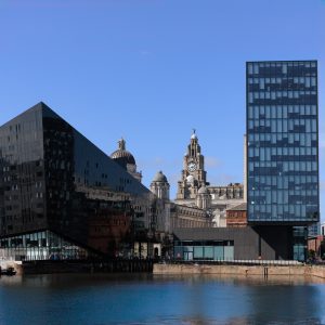View of the Royal Liver Building reflected in the black glass of Mann Island, Liverpool waterfront